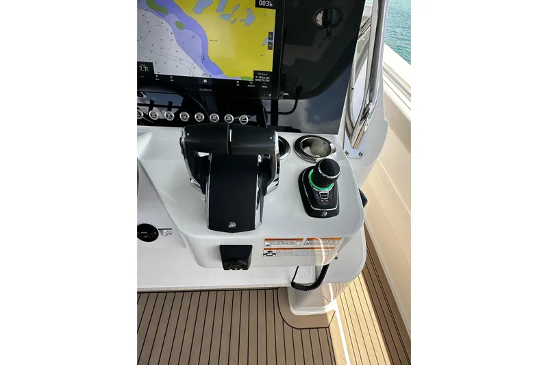 Yacht Photos Pics Control panel of 2022 Bertram 39 CC boat with navigation display and joystick.