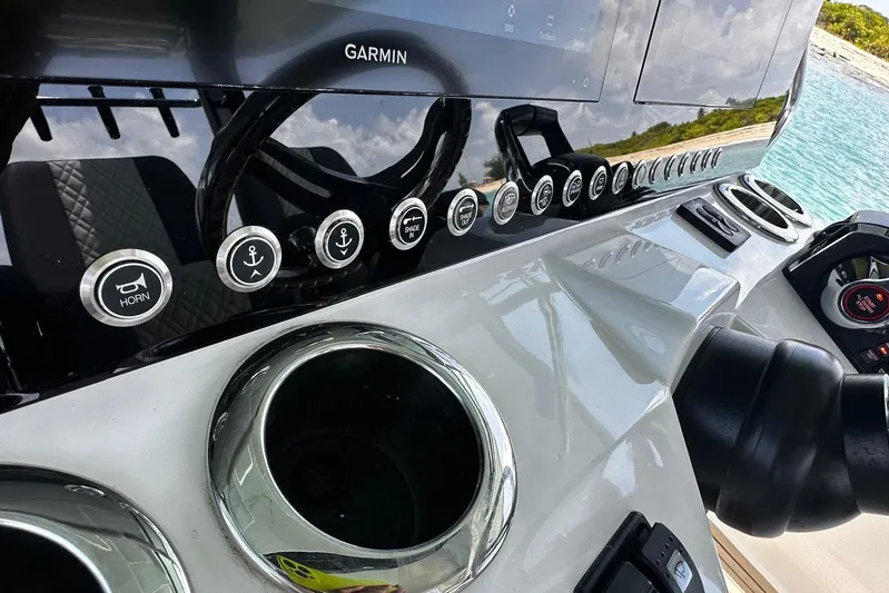  Yacht Photos Pics 2022 Bertram 39 CC boat dashboard with Garmin display and control buttons.