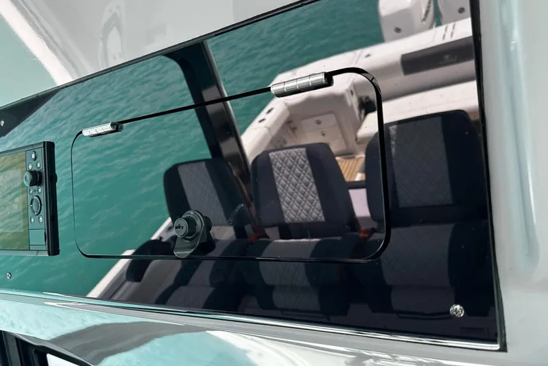  Yacht Photos Pics Control panel and seating on a 2022 Bertram 39 CC boat, reflecting turquoise water.