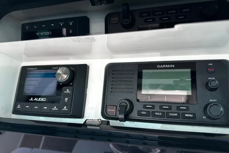  Yacht Photos Pics JL Audio and Garmin devices on a 2022 Bertram 39 CC boat dashboard.