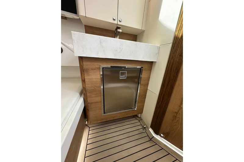  Yacht Photos Pics 2022 Bertram 39 CC interior with wood paneling and stainless steel appliance.