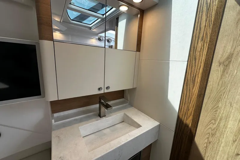  Yacht Photos Pics Modern bathroom vanity in 2022 Bertram 39 CC yacht, featuring sleek design and wood accents.