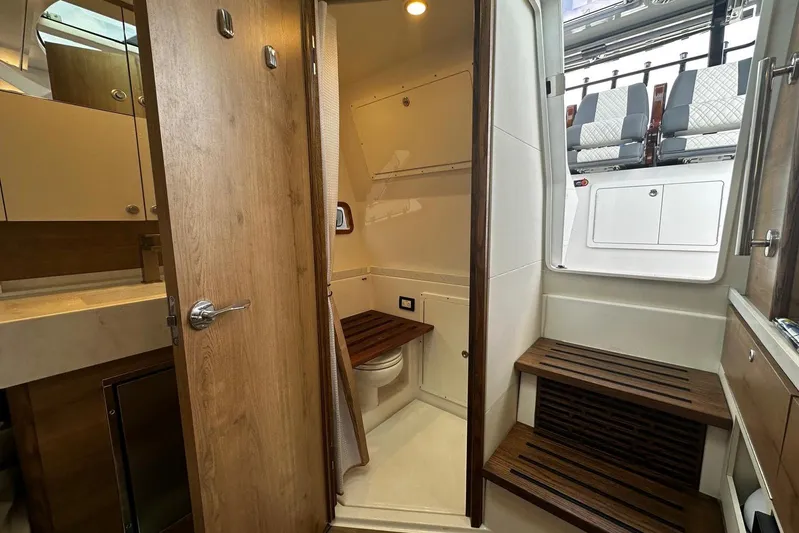  Yacht Photos Pics 2022 Bertram 39 CC interior with wooden finishes and modern amenities.