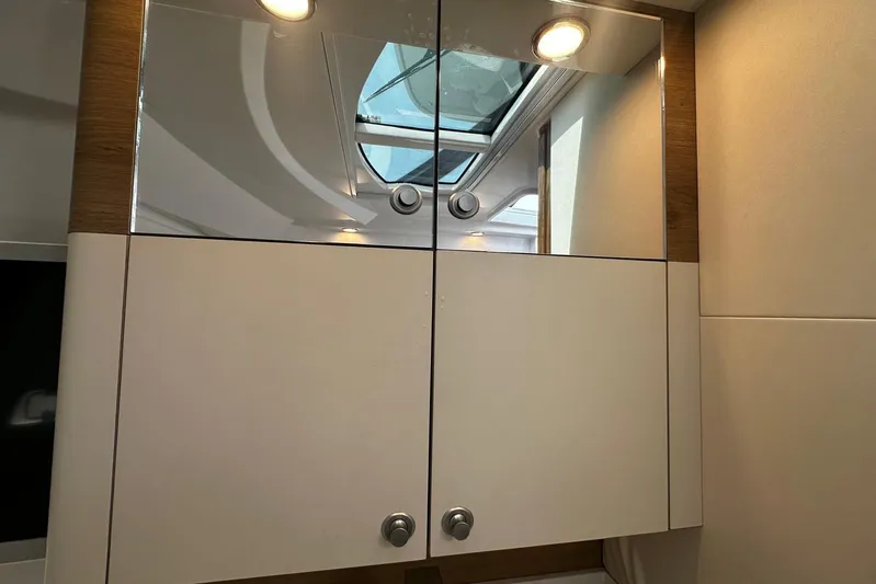  Yacht Photos Pics Modern interior of 2022 Bertram 39 CC yacht with mirrored cabinet and skylight.