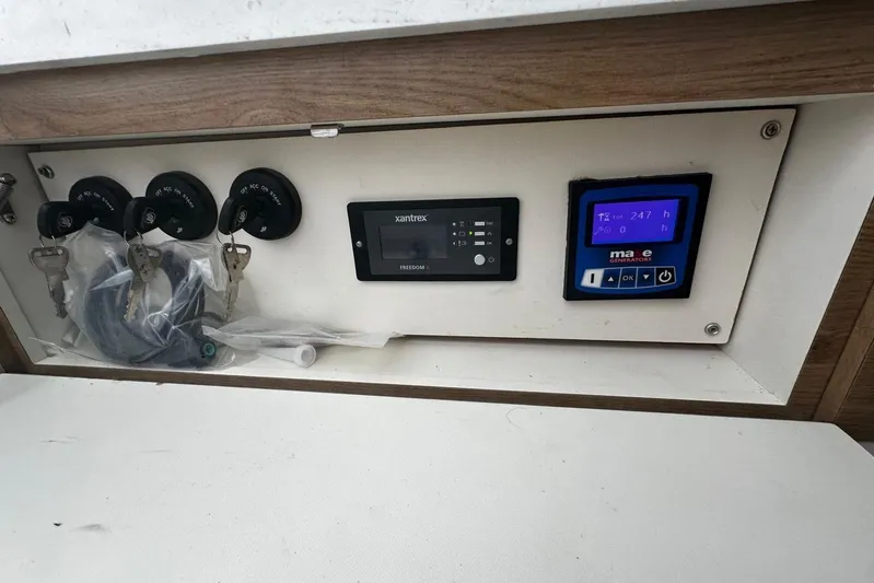  Yacht Photos Pics Control panel of a 2022 Bertram 39 CC boat with keys and digital displays.