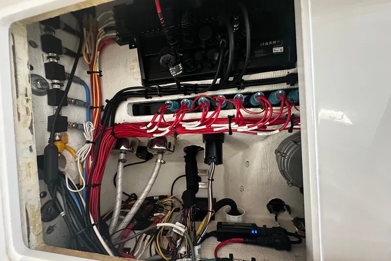  Yacht Photos Pics Electrical wiring inside a 2022 Bertram 39 CC boat, showcasing organized cables and components.