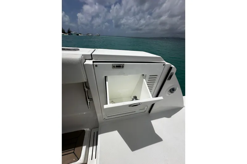  Yacht Photos Pics 2022 Bertram 39 CC boat with open storage compartment, ocean view in background.