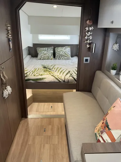  Yacht Photos Pics Modern Bali 4.2 yacht interior with cozy bedroom, wooden flooring, and stylish decor, 2023 model.