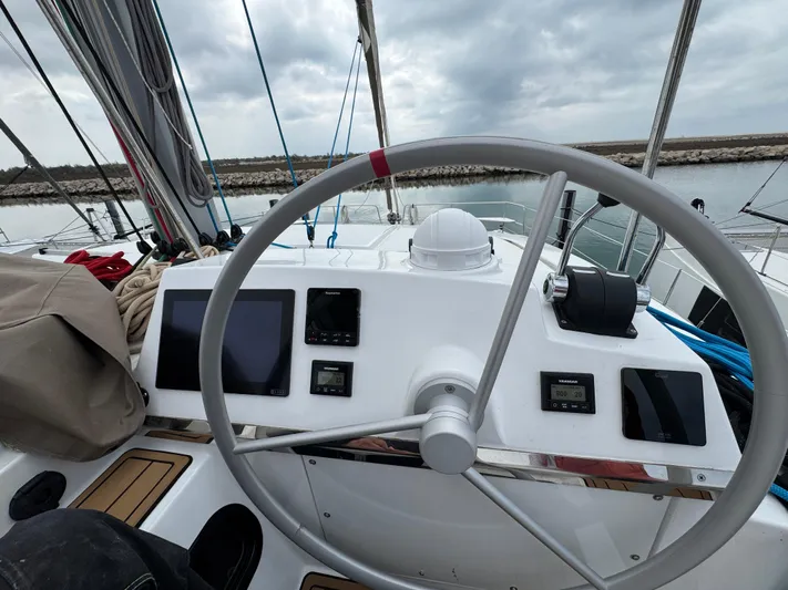  Yacht Photos Pics Steering wheel and control panel of 2023 Bali 4.2 yacht, docked in a marina.