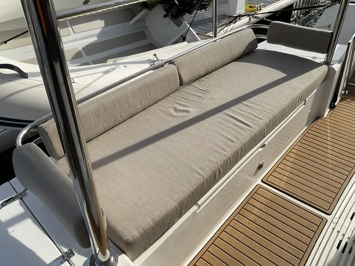  Yacht Photos Pics Comfortable seating area on 2023 Bali 4.2 yacht with beige cushions and wooden deck.
