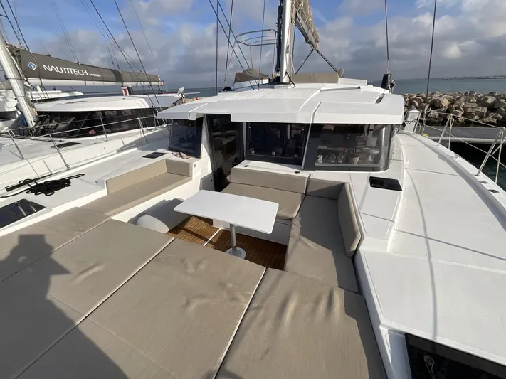  Yacht Photos Pics 2023 Bali 4.2 catamaran with spacious deck and seating area, docked at marina.