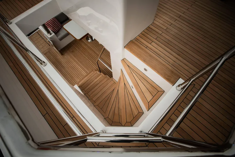  Yacht Photos Pics Staircase on 2024 Nomad 75 SUV yacht with sleek wooden flooring and modern design.
