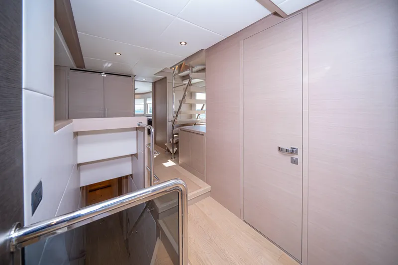  Yacht Photos Pics Luxurious interior of 2024 Nomad 75 SUV yacht with modern design and sleek staircase.