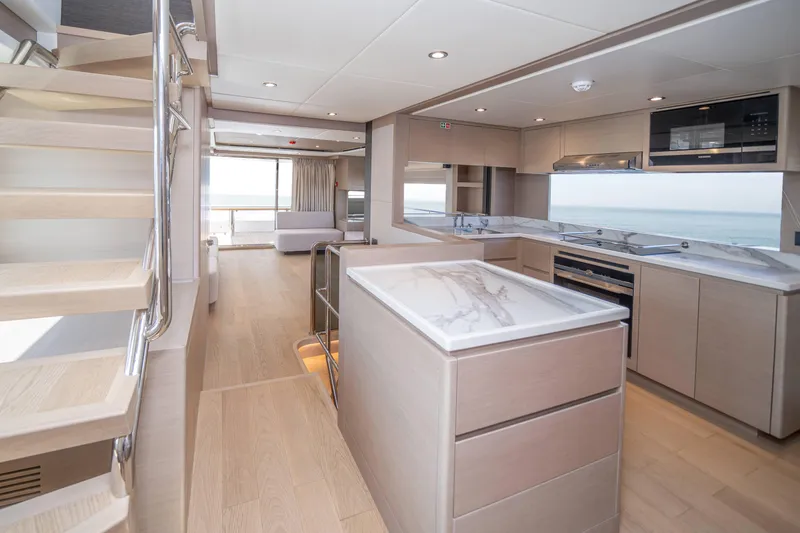  Yacht Photos Pics Luxurious interior of 2024 Nomad 75 SUV yacht with modern kitchen and ocean view.