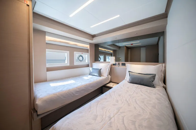  Yacht Photos Pics Luxurious twin bedroom in 2024 Nomad 75 SUV yacht, featuring modern design and elegant decor.