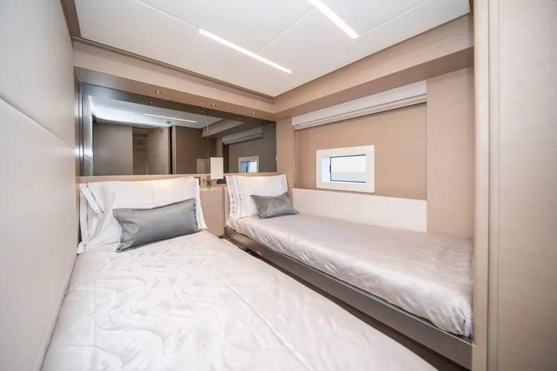  Yacht Photos Pics Luxurious twin bedroom in 2024 Nomad 75 SUV yacht, featuring modern design and cozy bedding.