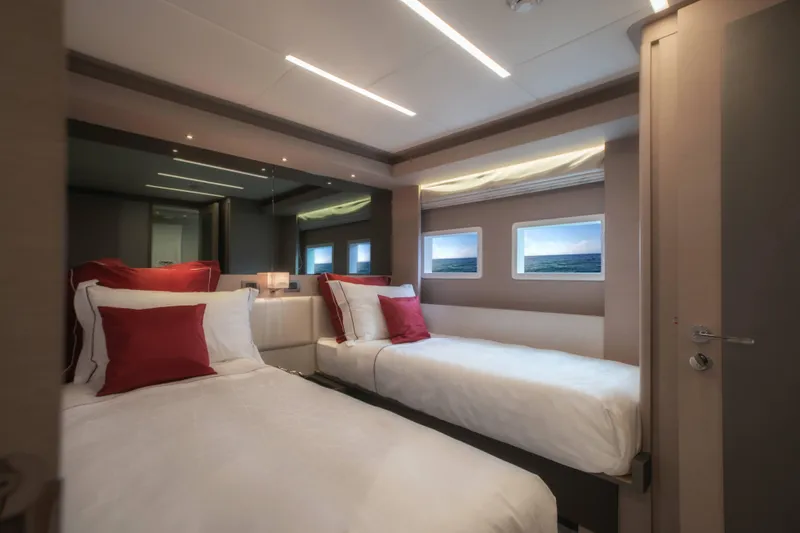  Yacht Photos Pics Luxurious bedroom interior of 2024 Nomad 75 SUV yacht with twin beds and elegant decor.