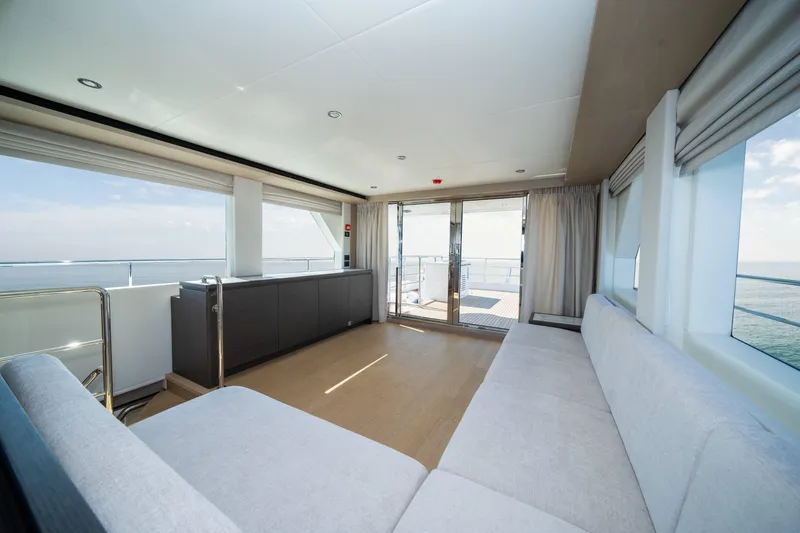  Yacht Photos Pics Luxurious interior of 2024 Nomad 75 SUV yacht with panoramic ocean views.
