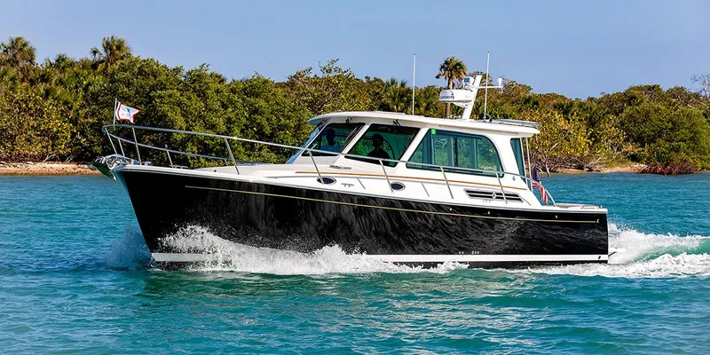 Call For Availability Yacht Photos Pics 2025 Back Cove 372 cruising on clear blue water.