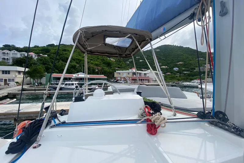 Mirabella Yacht Photos Pics Bali 4.2 catamaran docked at marina, surrounded by lush green hills, 2022 model.