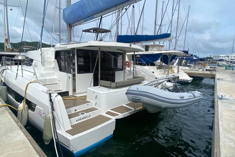 Mirabella Yacht Photos Pics 2022 Bali 4.2 catamaran docked at marina with inflatable dinghy attached.