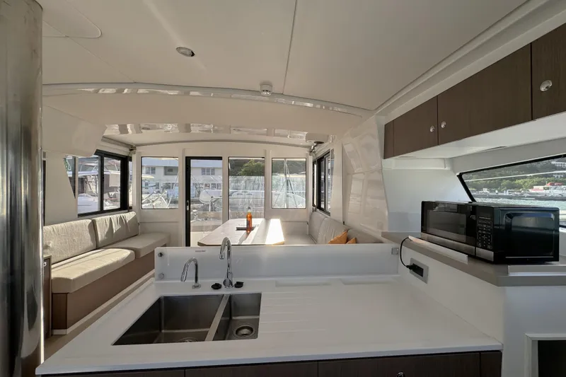 Mirabella Yacht Photos Pics Modern interior of 2022 Bali 4.2 yacht with kitchen and seating area.