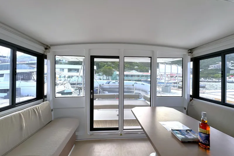 Mirabella Yacht Photos Pics Interior of 2022 Bali 4.2 catamaran with seating, table, and marina view.