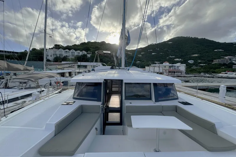 Mirabella Yacht Photos Pics 2022 Bali 4.2 catamaran docked at marina with scenic hillside backdrop.