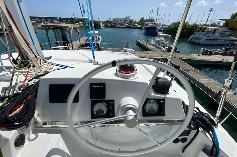 Mirabella Yacht Photos Pics Helm of 2022 Bali 4.2 catamaran docked at marina, featuring navigation instruments.