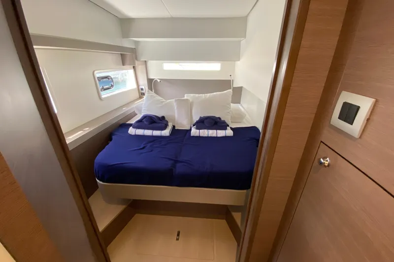 Mirabella Yacht Photos Pics Luxurious cabin interior of 2022 Bali 4.2 yacht with blue bedding and window view.