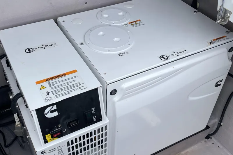 Mirabella Yacht Photos Pics Cummins generator in a 2022 Bali 4.2, featuring safety warnings and control panel.