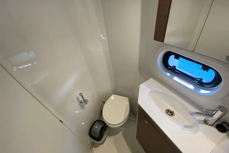 Mirabella Yacht Photos Pics Modern bathroom in 2022 Bali 4.2 yacht with sleek fixtures and porthole window.