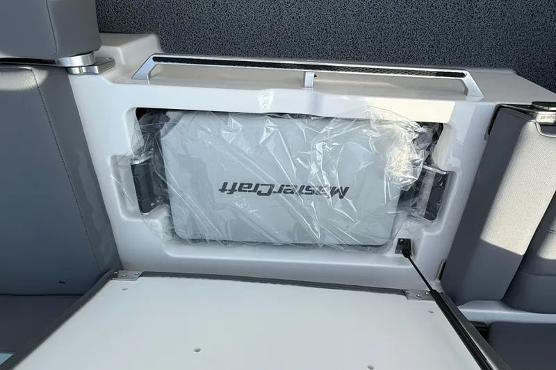  Yacht Photos Pics 2026 MasterCraft XT24 boat storage compartment with protective cover.