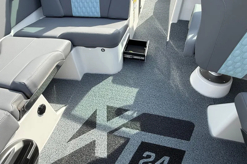  Yacht Photos Pics Interior of 2026 MasterCraft XT24 boat with gray seating and logo on carpet.