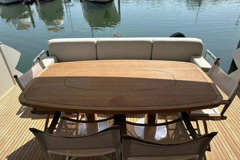  Yacht Photos Pics Luxury Monte Carlo Yachts MCY 70, 2019 model, featuring elegant teak deck dining area.