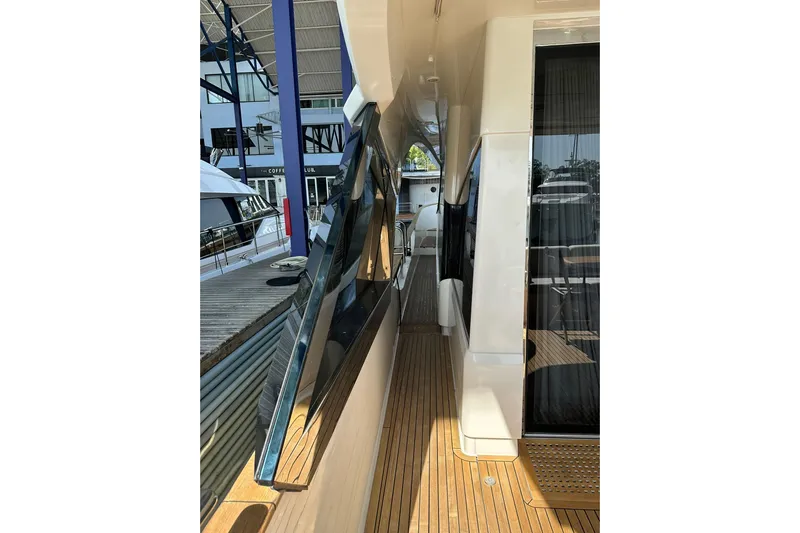  Yacht Photos Pics 2019 Monte Carlo Yachts MCY 70 side deck with sleek design and wooden flooring.