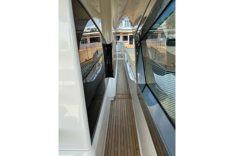  Yacht Photos Pics Side deck view of 2019 Monte Carlo Yachts MCY 70, featuring sleek design and teak flooring.