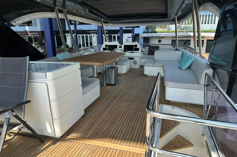  Yacht Photos Pics Luxurious 2019 Monte Carlo Yachts MCY 70 deck with elegant seating and dining area.