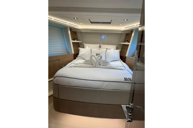  Yacht Photos Pics Luxurious bedroom interior of 2019 Monte Carlo Yachts MCY 70 with elegant bedding.