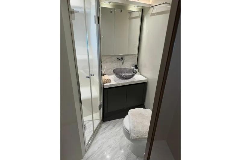  Yacht Photos Pics Luxurious bathroom in 2019 Monte Carlo Yachts MCY 70, featuring modern fixtures and elegant design.