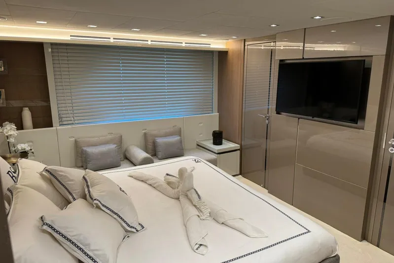  Yacht Photos Pics Luxurious bedroom interior of 2019 Monte Carlo Yachts MCY 70 with elegant decor and modern amenities.