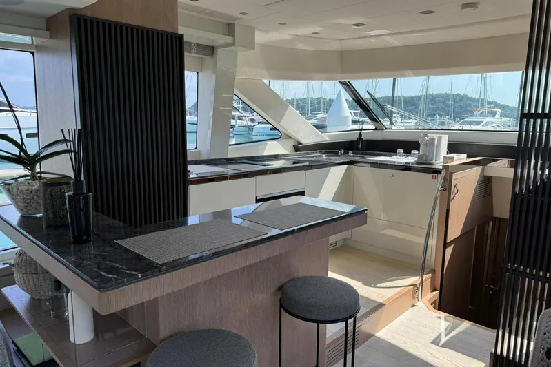  Yacht Photos Pics Luxurious interior of 2019 Monte Carlo Yachts MCY 70 with modern kitchen and panoramic windows.