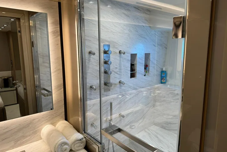  Yacht Photos Pics Luxurious bathroom in 2019 Monte Carlo Yachts MCY 70 with marble shower and modern fixtures.
