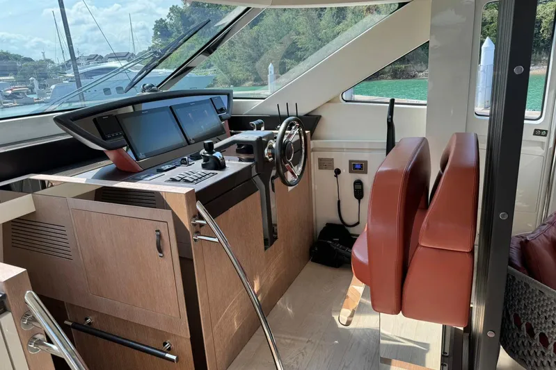  Yacht Photos Pics 2019 Monte Carlo Yachts MCY 70 helm with modern controls and leather seating.