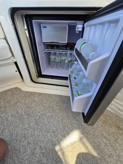  Yacht Photos Pics Open mini fridge on 2002 Sea Ray 560 Sedan Bridge, stocked with bottled water.