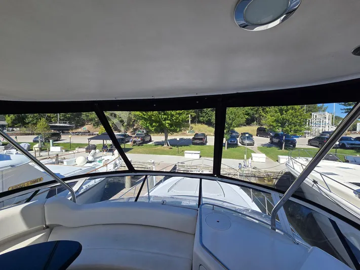  Yacht Photos Pics 2002 Sea Ray 560 Sedan Bridge interior view with marina and parked cars in background.