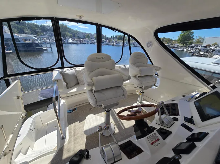  Yacht Photos Pics Luxurious 2002 Sea Ray 560 Sedan Bridge interior with helm and plush seating.