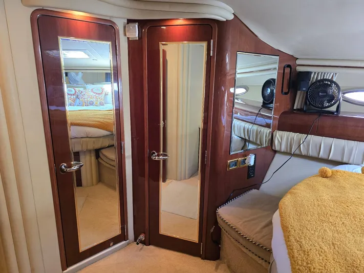  Yacht Photos Pics Luxurious interior of 2002 Sea Ray 560 Sedan Bridge with mirrored doors and elegant furnishings.
