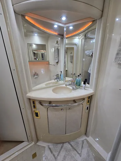  Yacht Photos Pics Luxurious bathroom in 2002 Sea Ray 560 Sedan Bridge yacht with modern fixtures and ambient lighting.