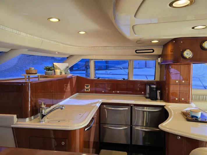  Yacht Photos Pics Luxurious kitchen interior of 2002 Sea Ray 560 Sedan Bridge yacht with modern amenities.